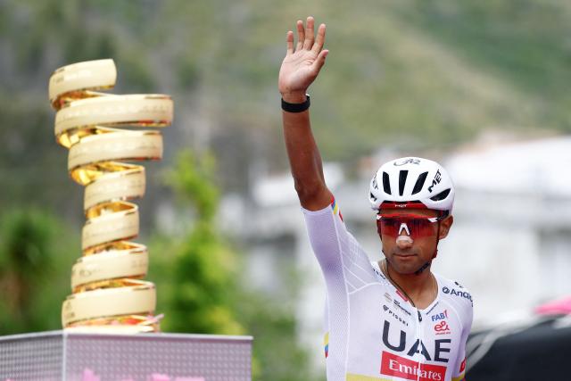 UAE Team Emirates - XRG Ecuadorian rider Jhonatan Narvaez winner of the 4th stage waves as he walks past the Giro d'Italia trophy ("trofeo senza fine") on the podium ahead of the 5th stage of the Giro d'Italia 2026 - Tour of Italy cycling race between Praia a Mare and Potenza, southern Italy on May 13, 2026. (Photo by Luca Bettini / AFP)