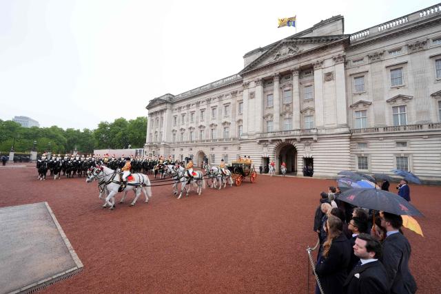 Britain's King Charles III and Britain's Queen Camilla depart Buckingham Palace to attend the State Opening of Parliament, in London on May 13, 2026.  (Photo by Yui Mok / POOL / AFP)