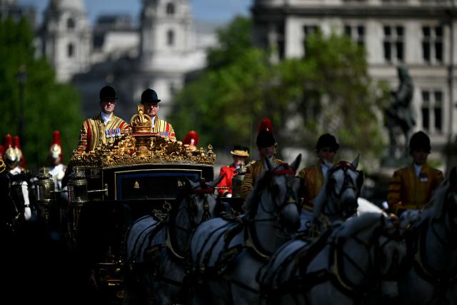 The carriage carrying Britain's King Charles III and Britain's Queen Camilla arrives at the Houses of Parliament in London on May 13, 2026, for the State Opening of Parliament.  (Photo by JUSTIN TALLIS / POOL / AFP)