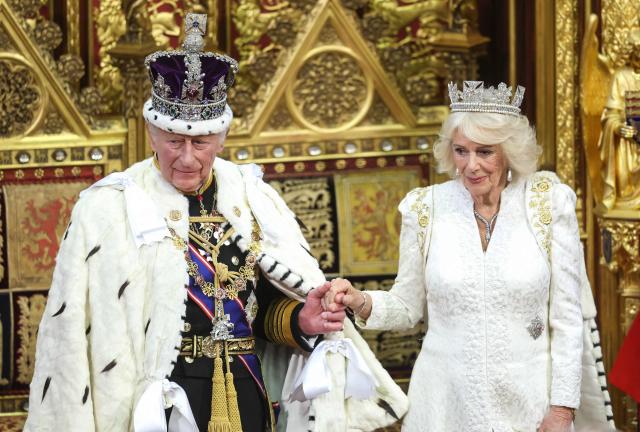 Britain's King Charles III, wearing the Imperial State Crown and the Robe of State, smiles with Britain's Queen Camilla ahead of making his speech in the House of Lords chamber, during the State Opening of Parliament, at the Houses of Parliament, in London on May 13, 2026. (Photo by Chris Jackson / POOL / AFP)
