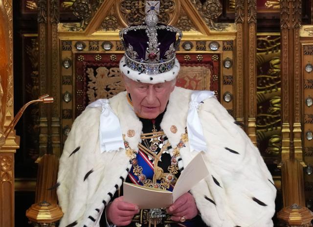 Britain's King Charles III, wearing the Imperial State Crown and the Robe of State, sits on the The Sovereign's Throne delivering his speech in the House of Lords chamber, during the State Opening of Parliament, at the Houses of Parliament, in London on May 13, 2026. (Photo by Kirsty Wigglesworth / POOL / AFP)