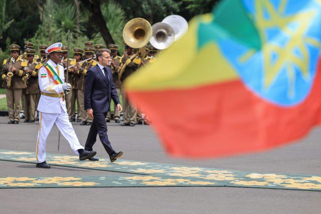 France's President Emmanuel Macron (2nd L) inspects the guard of honour at the Presidential Palace in Addis Ababa on May 13, 2026. (Photo by Ludovic MARIN / AFP)