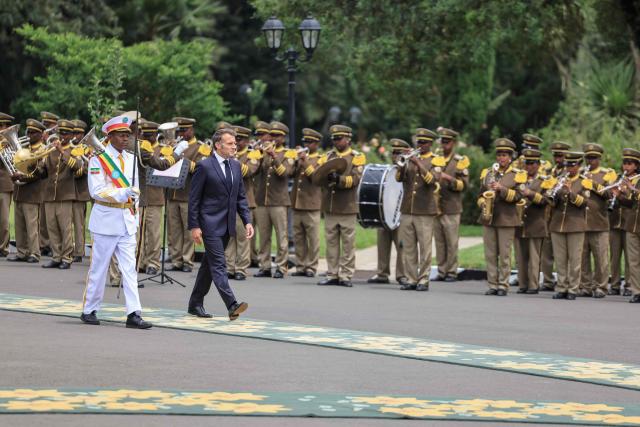 France's President Emmanuel Macron (2nd L) inspects the guard of honour at the Presidential Palace in Addis Ababa on May 13, 2026. (Photo by Ludovic MARIN / AFP)