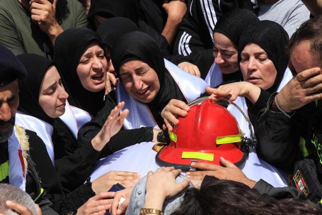 Mourners attend the funerals of two rescuers who were reportedly killed in Israeli airstrikes in Nabatieh the previous day, in the southern city of Sidon on May 13, 2026. Israel hammered south Lebanon with strikes on May 12 ahead of talks between the two countries in Washington, as Beirut reported 380 people killed in Israeli attacks since an April 17 ceasefire took effect. (Photo by Mahmoud ZAYYAT / AFP)