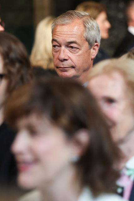 Reform UK leader Nigel Farage (top) looks on at the House of Commons chamber during the State Opening of Parliament at the Palace of Westminster in London on May 13, 2026. (Photo by Toby Melville / POOL / AFP)