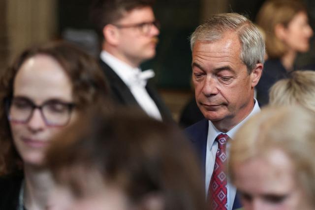 Reform UK leader Nigel Farage (R) looks on at the House of Commons chamber during the State Opening of Parliament at the Palace of Westminster in London on May 13, 2026. (Photo by Toby Melville / POOL / AFP)