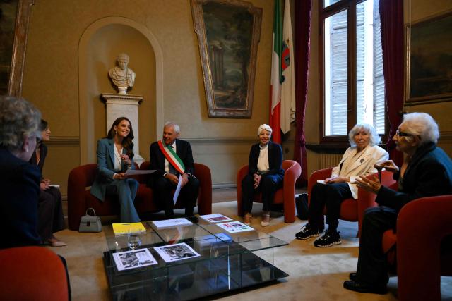Britain's Catherine, Princess of Wales sits next to the mayor of Reggio Emilia, Marco Massari during a meeting with citizens at Reggio Emilia's town hall as part of a two-day visit in Italy, on May 13, 2026. (Photo by Marco BERTORELLO / POOL / AFP)