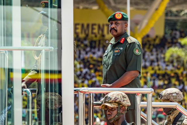 Muhoozi Kainerugaba (C), son of Yoweri Museveni and Uganda’s Chief of Defence Forces, inspects a military parade from a vehicle during the inauguration ceremony of his father following his re-election as president at the Kololo Ceremonial Grounds in Kampala on May 12, 2026. (Photo by BADRU KATUMBA / AFP)