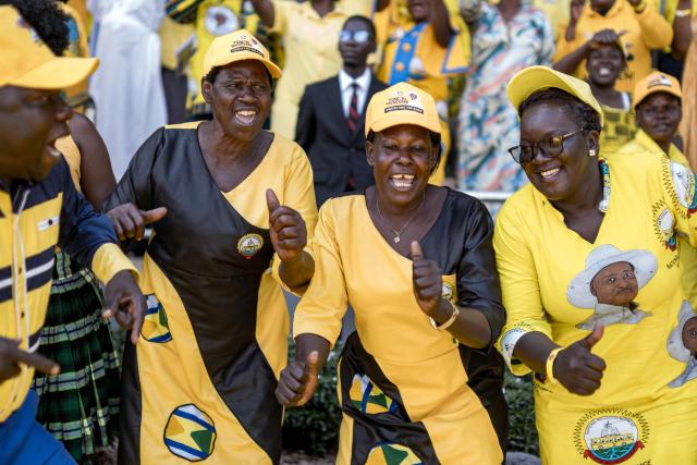 Supporters of Uganda’s President Yoweri Museveni dance during the inauguration ceremony following his re-election as president at the Kololo Ceremonial Grounds in Kampala on May 12, 2026. (Photo by BADRU KATUMBA / AFP)