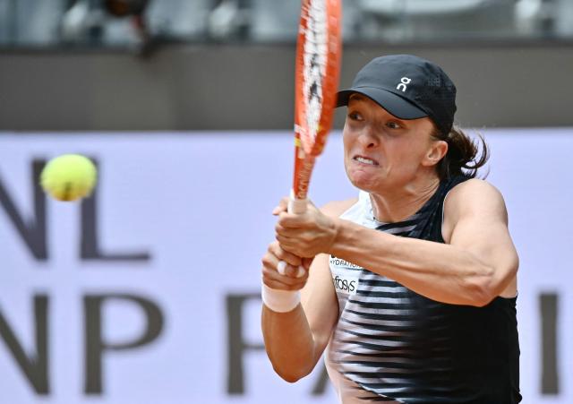 Poland's Iga Swiatek hits a return to USA's Jessica Pegula during the ATP Rome Open tennis tournament at Foro Italico in Rome on May 13, 2026. (Photo by Filippo MONTEFORTE / AFP)