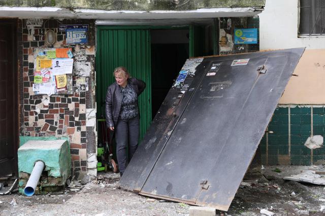 A local resident stands on the porch of a damaged residential building following an air attack in Odesa on May 13, 2026, amid the Russian invasion in Ukraine. (Photo by Oleksandr GIMANOV / AFP)