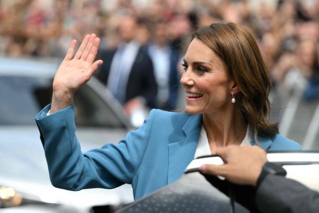 Britain's Catherine, Princess of Wales waves to the crowd as she leaves Reggio Emilia's town hall as part of a two-day visit in Italy, on May 13, 2026. (Photo by Marco BERTORELLO / POOL / AFP)