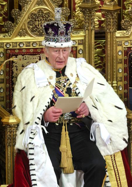 Britain's King Charles III, wearing the Imperial State Crown and the Robe of State, makes his speech in the House of Lords chamber, during the State Opening of Parliament, at the Houses of Parliament, in London on May 13, 2026. (Photo by Chris Jackson / POOL / AFP)