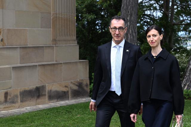 Baden-Wuerttemberg's new State Premier Cem Oezdemir (L) of the Greens and his wife Flavia Zaka arrive at Villa Reitzenstein in Stuttgart, southern Germany, after Oezdemir took over the post, on May 13, 2026.  (Photo by Bernd Weißbrod / POOL / AFP)