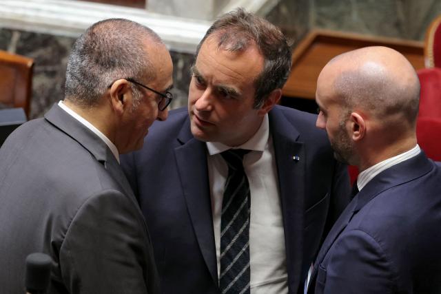 France's Prime Minister Sebastien Lecornu (C) stands with France's Interior Minister Laurent Nunez (L) and France's junior Minister in charge of Europe Benjamin Haddad (R) ahead of a session of questions to the government at The National Assembly, France's lower house of parliament in Paris on May 13, 2026. (Photo by Thomas SAMSON / AFP)