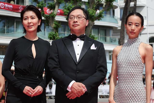 (From L) Japanese actress Takako Matsu, Japanese director, screenwriter, editor, and producer Koji Fukada and Japanese actress Shizuka Ishibashi arrive for the screening of the film "Nagi Notes" at the 79th edition of the Cannes Film Festival in Cannes, southern France on May 13, 2026. (Photo by Valery HACHE / AFP)