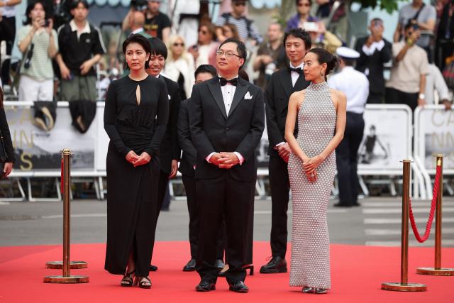 (From L, first row) Japanese actress Takako Matsu, Japanese director, screenwriter, editor, and producer Koji Fukada and Japanese actress Shizuka Ishibashi arrive for the screening of the film "Nagi Notes" at the 79th edition of the Cannes Film Festival in Cannes, southern France on May 13, 2026. (Photo by Valery HACHE / AFP)