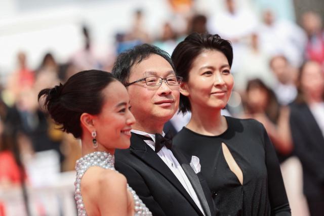 (From L) Japanese actress Shizuka Ishibashi, Japanese director, screenwriter, editor, and producer Koji Fukada and Japanese actress Takako Matsu arrive for the screening of the film "Nagi Notes" at the 79th edition of the Cannes Film Festival in Cannes, southern France on May 13, 2026. (Photo by Valery HACHE / AFP)