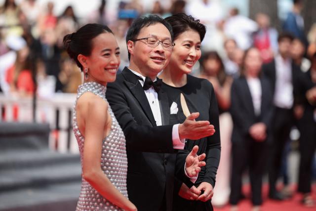 (From L) Japanese actress Shizuka Ishibashi, Japanese director, screenwriter, editor, and producer Koji Fukada and Japanese actress Takako Matsu arrive for the screening of the film "Nagi Notes" at the 79th edition of the Cannes Film Festival in Cannes, southern France on May 13, 2026. (Photo by Valery HACHE / AFP)