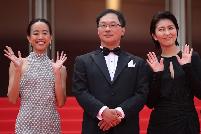 (From L) Japanese actress Shizuka Ishibashi, Japanese director, screenwriter, editor, and producer Koji Fukada and Japanese actress Takako Matsu arrive for the screening of the film "Nagi Notes" at the 79th edition of the Cannes Film Festival in Cannes, southern France on May 13, 2026. (Photo by Valery HACHE / AFP)