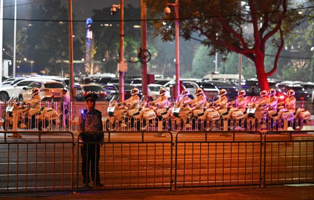 US President Donald Trump's motorcade arrives at the Four Seasons Hotel under police escort, in Beijing on May 13, 2026. (Photo by Pedro PARDO / AFP)