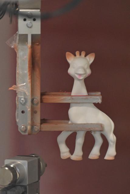 This photograph shows a Sophie la girafe (Sophie the Giraffe) toy made by French baby care products and toys company Vulli in the production line's painting booth of its new production site in Saint-Nabord, north-eastern France, on May 12, 2026. Vulli, which has made "Made in France" its hallmark, has admitted on May 4, 2026 manufacturing giraffe toys in China, as revealed in an investigation by the online media outlet Mediapart, but insists that this is a temporary situation. The French Directorate-General for Competition, Consumer Affairs and Fraud Control (DGCCRF) has launched an investigation as claiming a product to be of French origin when it is not may constitute a misleading commercial practise, punishable by a criminal fine of up to 10% of turnover. (Photo by Jean-Christophe VERHAEGEN / AFP)