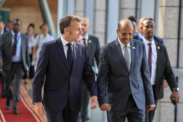 France's President Emmanuel Macron (L) arrives for his trilateral meeting with unseen United Nations' Secretary-General Antonio Guterres and African Union Commission's President Mahamoud Ali Youssouf (R) at the African Union (AU) headquarters in Addis Ababa on May 13, 2026. (Photo by Ludovic MARIN / AFP)