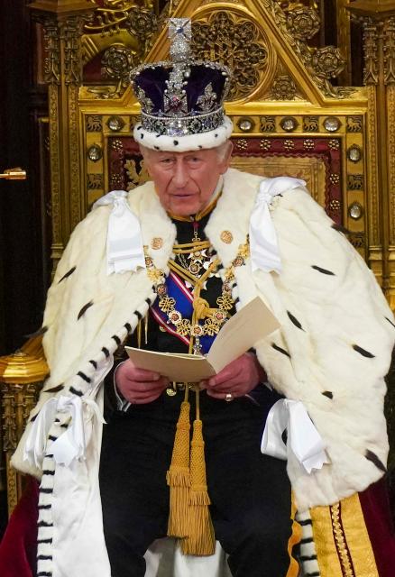 Britain's King Charles III, wearing the Imperial State Crown and the Robe of State, reads the King's Speech in the House of Lords chamber, during the State Opening of Parliament, at the Houses of Parliament, in London on May 13, 2026. (Photo by Arthur Edwards / POOL / AFP)