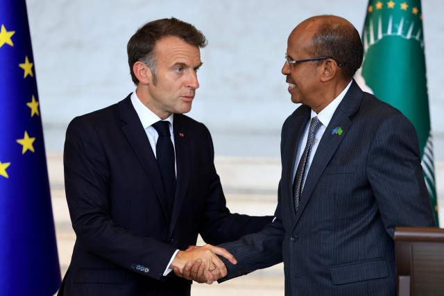 France's President Emmanuel Macron (L) shakes hands with African Union Commission's President Mahamoud Ali Youssouf (R) during a press conference at the African Union (AU) headquarters in Addis Ababa on May 13, 2026. (Photo by Ludovic MARIN / AFP)