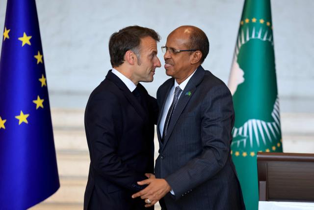 France's President Emmanuel Macron (L) shakes hands with African Union Commission's President Mahamoud Ali Youssouf (R) during a press conference at the African Union (AU) headquarters in Addis Ababa on May 13, 2026. (Photo by Ludovic MARIN / AFP)