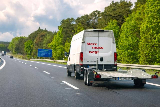 A van with the slogan "Merz muss weg" (Merz must go) travels on German motorway A13 in southern Brandenburg, eastern Germany near the town of Freiwalde on May 13, 2026. Never before has a German government been this unpopular after only one year in office as that of Chancellor Friedrich Merz polls suggest with the the far-right AfD capitalizing on it the most.. (Photo by Odd ANDERSEN / AFP)