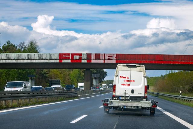 A van with the slogan "Merz muss weg" (Merz must go) travels on German motorway A13 in southern Brandenburg, eastern Germany near the town of Freiwalde on May 13, 2026. Never before has a German government been this unpopular after only one year in office as that of Chancellor Friedrich Merz polls suggest with the the far-right AfD capitalizing on it the most.. (Photo by Odd ANDERSEN / AFP)