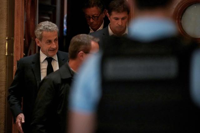 French former president Nicolas Sarkozy leaves the courtroom after prosecutors requested a seven-year prison sentence for him in an appeal trial on charges that he sought Libyan financing for his 2007 election in exchange for helping improve Tripoli's image after deadly bombing, at the Palais de Justice courthouse in Paris on May 13, 2026. Sarkozy has always denied any wrongdoing but last year became modern France's first former president to have gone to jail over the case, before he was released after 20 days pending his appeal trial. Prosecutors had also requested seven years in the first trial, and he was sentenced to five over seeking to acquire funding from Muammar Gaddafi's Libya for the campaign. (Photo by Dimitar DILKOFF / AFP)