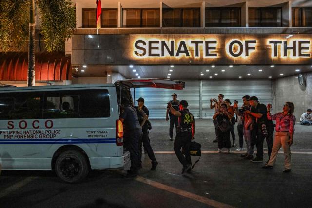 Members of the Scene of the Crime Operatives (SOCO) arrive after the exchange of gunshots inside the Senate of the Philippines in Pasay, Metro Manila on May 13, 2026. Multiple gunshots sent Philippine senators into hiding in their offices late on May 13, AFP journalists said, as a legislator wanted by the International Criminal Court has sought refuge in the building. (Photo by Jam STA ROSA / AFP)