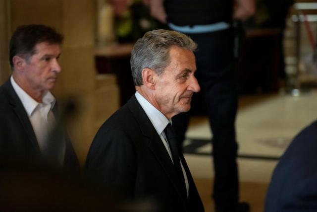 French former president Nicolas Sarkozy leaves the courtroom after prosecutors requested a seven-year prison sentence for him in an appeal trial on charges that he sought Libyan financing for his 2007 election in exchange for helping improve Tripoli's image after deadly bombing, at the Palais de Justice courthouse in Paris on May 13, 2026. Sarkozy has always denied any wrongdoing but last year became modern France's first former president to have gone to jail over the case, before he was released after 20 days pending his appeal trial. Prosecutors had also requested seven years in the first trial, and he was sentenced to five over seeking to acquire funding from Muammar Gaddafi's Libya for the campaign. (Photo by Dimitar DILKOFF / AFP)