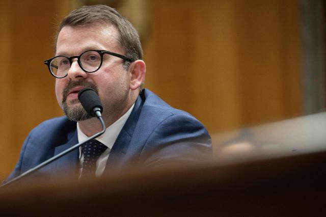 James Erdman III, senior operations officer at the CIA, testifies during a Senate Homeland Security and Governmental Affairs Committee hearing on Capitol Hill in Washington, DC, on May 13, 2026. Erdman testified that he believes there was an effort within the Intelligence Community to downplay the possibility that the COVID-19 pandemic originated in a "lab leak." (Photo by Jim WATSON / AFP)