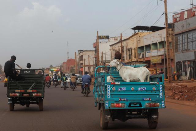 TOPSHOT - Sheep are seeing on the back of a vehicle ahead of the Muslim festival of Eid al-Adha, locally known as Tabaski, in Bamako, on May 12, 2026. (Photo by AFP)