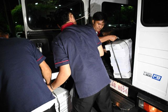 Workers unload documents of articles of impeachment at the Senate premises from the House of Representatives in Manila on May 13, 2026. Philippine lawmakers voted on May 11 by a wide margin to impeach Vice President Sara Duterte for the second time, setting the stage for a Senate trial that could end her 2028 presidential bid. (Photo by Ted ALJIBE / AFP)