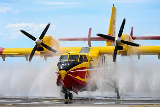 A Canadair water-bomber aircraft is cleaned afterwards to prevent corrosion from salt water at the Nimes-Garons firefighters air base in Garons, southern France, on May 13, 2026 (Photo by Gabriel BOUYS / AFP)