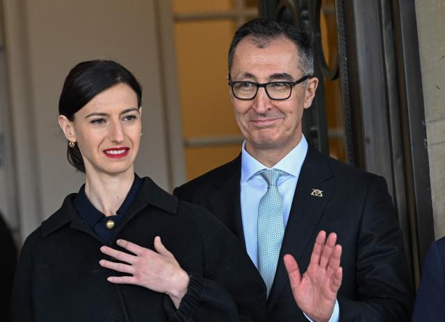Baden-Wuerttemberg's new State Premier Cem Oezdemir of the Greens party and his wife Flavia Zaka wave at Villa Reitzenstein in Stuttgart, southern Germany, after Oezdemir took over the post, on May 13, 2026.  (Photo by Bernd Weißbrod / POOL / AFP)