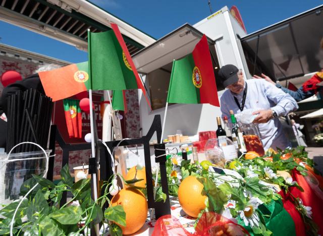 A man prepares Portuguese specialties during the ESC side event 'Eurovision Market Contest' at Vienna's Naschmarkt, Austria, where several food and souvenir stalls from different ESC participating countries take part, on May 13, 2026. (Photo by Joe Klamar / AFP)
