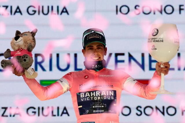 TOPSHOT - New overall leader Bahrain - Victorious Portuguese rider Afonso Eulalio celebrates on the podium after the 5th stage of the Giro d'Italia 2026 - Tour of Italy cycling race between Praia a Mare and Potenza, southern Italy on May 13, 2026. (Photo by Luca BETTINI / AFP)