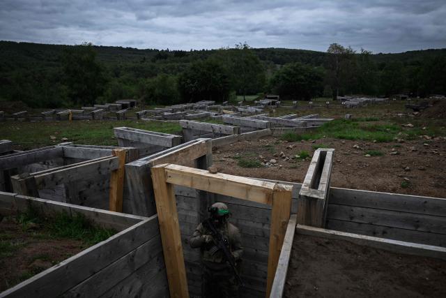 A French Foreign Legion paratrooper from the 2nd Foreign Parachute Regiment (2e REP) holds a defensive position in a trench network before an assault during exercise LIBECCIU 2026, in La Courtine, central France, on May 13, 2026. More than 700 légionnaires are deployed across two French regions for the ten-day field exercise, sharpening the night-warfare and rapid-redeployment skills that define the Legion's airborne identity. (Photo by Philippe LOPEZ / AFP)