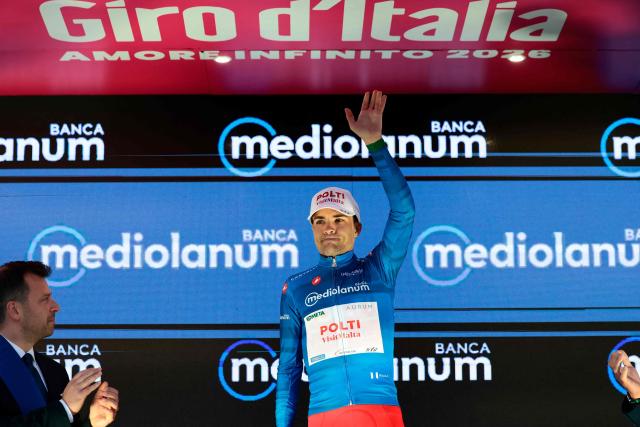 Team Polti VisitMalta Spanish rider Diego Sevilla, wearing the best climber's blue jersey (Maglia Azzura), celebrates on the podium after the 5th stage of the Giro d'Italia 2026 - Tour of Italy cycling race between Praia a Mare and Potenza, southern Italy on May 13, 2026. (Photo by Luca BETTINI / AFP)