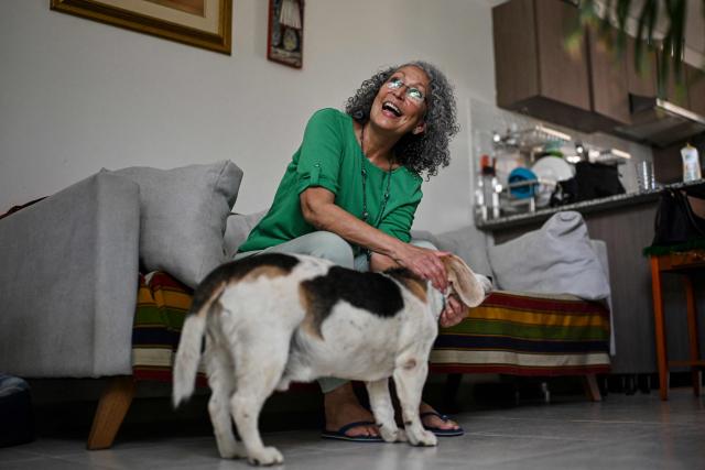 Former Sandinista National Liberation Front (FSLN) guerrilla commander Monica Baltodano pets her dog named Draco after an interview with AFP at her home in San Jose on May 10, 2026. Nicaragua’s co-president, Rosario Murillo, will not remain in power after Daniel Ortega’s death, said former guerrilla commander Baltodano in an interview with AFP whilst in exile in Costa Rica. (Photo by MARTIN BERNETTI / AFP)