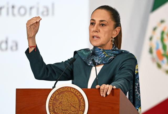 (FILES) Mexico’s President Claudia Sheinbaum gestures as she speaks to the media about security during her daily morning press conference at Palacio Nacional in Mexico City on May 12, 2026. Mexican President Claudia Sheinbaum fiercely rejected on May 13, 2026 accusations from a CNN investigation alleging CIA operatives carried out a "targeted assassination" outside Mexico City in March. (Photo by CARL DE SOUZA / AFP)