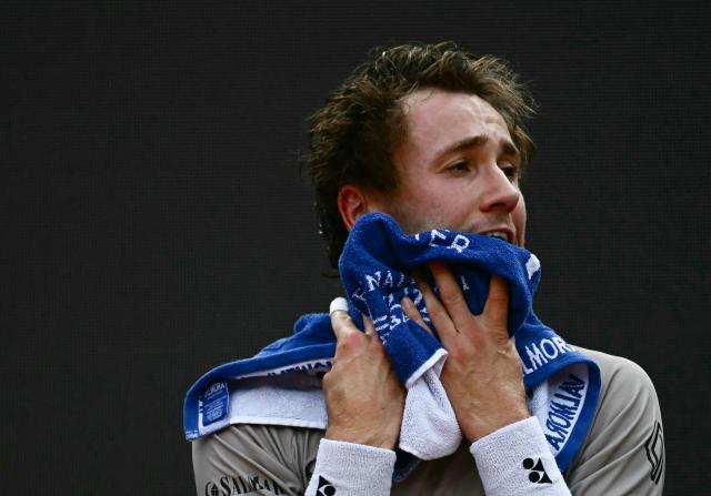 Norway's Casper Ruud wipes his face during a break while playing against Russia's Karen Khachanov in the ATP Rome Open tennis tournament at Foro Italico in Rome on May 13, 2026. (Photo by Filippo MONTEFORTE / AFP)