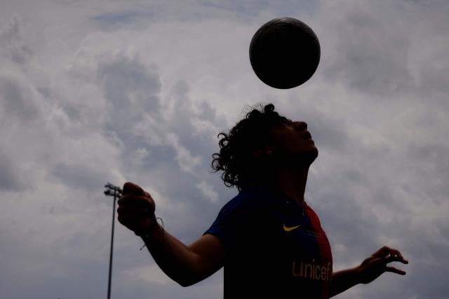 Daniel Garcia controls the ball with his head during a soccer match with his friends at Harvey Field in Kearny, New Jersey on May 9, 2026. Anthony Duro had hoped the World Cup coming to his soccer-mad New Jersey town would mean watching games at nearby MetLife Stadium, but sky-high ticket prices are beyond his budget. (Photo by Leonardo MUNOZ / AFP) / TO GO WITH AFP STORY BY BEN TURNER