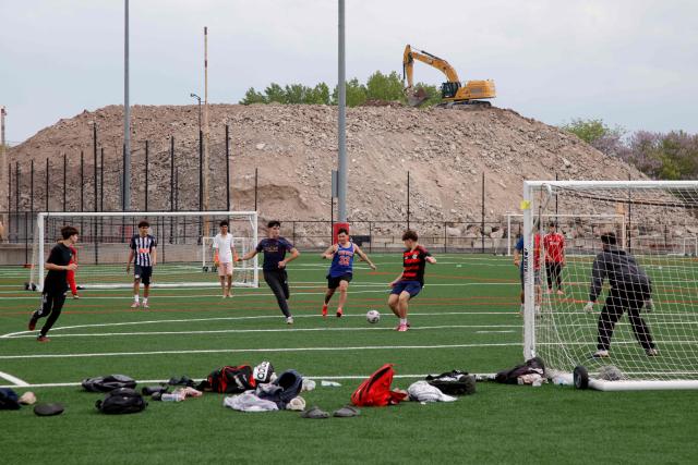 A group of young boys play soccer at Harvey Field in Kearny, New Jersey on May 9, 2026. Anthony Duro had hoped the World Cup coming to his soccer-mad New Jersey town would mean watching games at nearby MetLife Stadium, but sky-high ticket prices are beyond his budget. (Photo by Leonardo MUNOZ / AFP) / TO GO WITH AFP STORY BY BEN TURNER