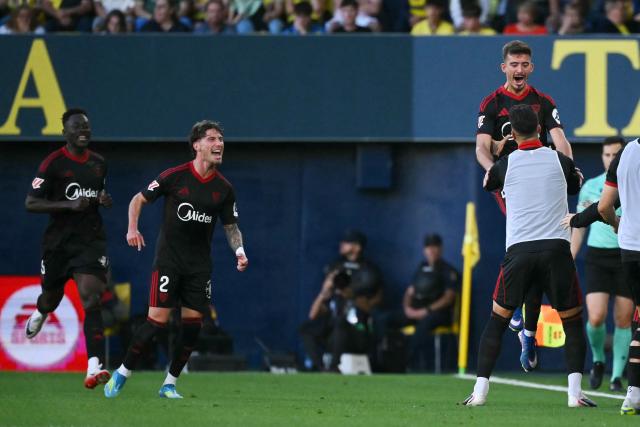 Sevilla's Spanish defender #04 Kike Salas (R) celebrates scoring his team's second goal during the Spanish league football match between Villarreal CF and Sevilla FC at La Ceramica Stadium in Vila-real on May 12, 2026. (Photo by JOSE JORDAN / AFP)